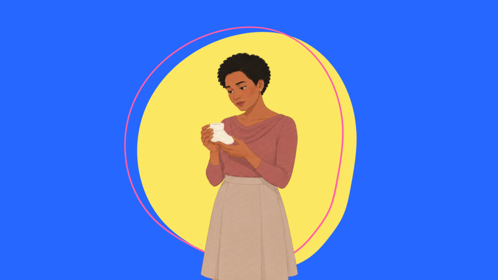 Woman looking at a baby sock while thinking about getting pregnant after 40